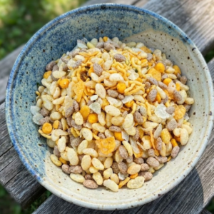 "Aved's Group Roasted Millet mixture served in a traditional wooden bowl, highlighting a healthy and organic Indian snack.", "Healthy roasted millet namkeen with seeds and nuts, a gluten-free and protein-rich snack option by Aved's Group.", "Close-up of crunchy Roasted Millet mixture, organic tea-time snack with no artificial preservatives."