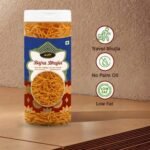 "Crispy golden Bajra Bhujia in a premium transparent jar, traditional Indian snacks photography on a white background."