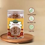 Healthy roasted Bajra chips in a transparent plastic jar. Crispy and gluten-free pearl millet (Bajra) snacks for healthy munching. Homemade Bajra chips packed in a clear jar, high angle view.