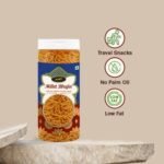 "Crispy Millet Bhujia in a clear transparent jar, healthy Indian savory snack, professional product photography on a white background."